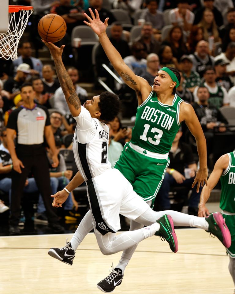 Dylan Harper of the San Antonio Spurs and Ron Harper Jr. of the Boston Celtics in the first half at Frost Bank Center on March 10, 2026 in San Antonio, Texas.Credit: Ronald Cortes/Getty