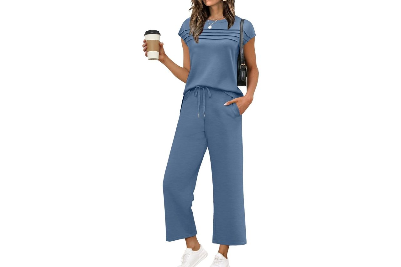 A person wearing a casual matching twopiece outfit and holding a coffee cup standing Credit: Amazon