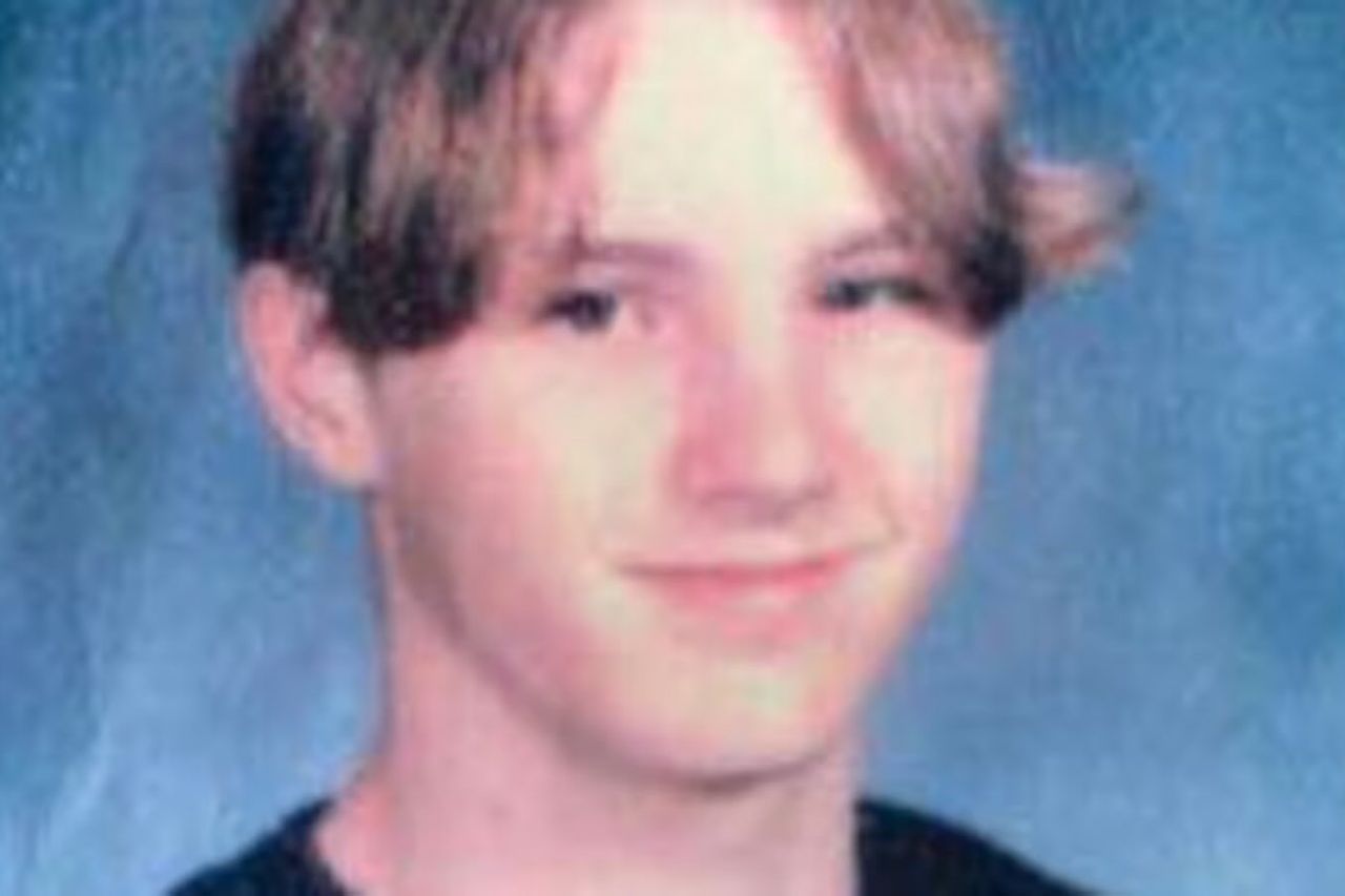 A teenager posing for a school portrait with a neutral expression wearing a dark shirt and having a classic hairstyle of the era Justin HocuttCredit: Missouri State Highway Patrol