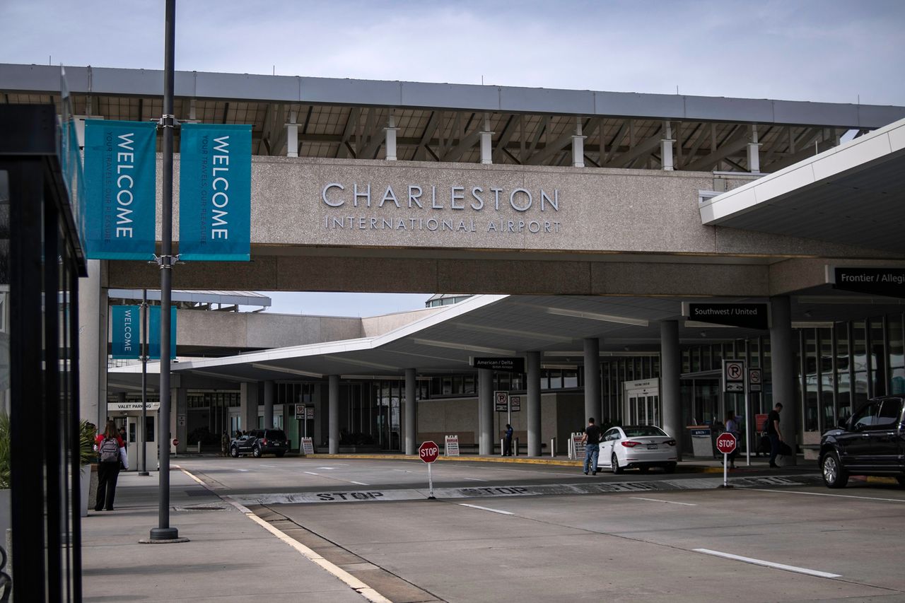 Entrance of Charleston International Airport with cars and welcome banners visible Charleston International Airport