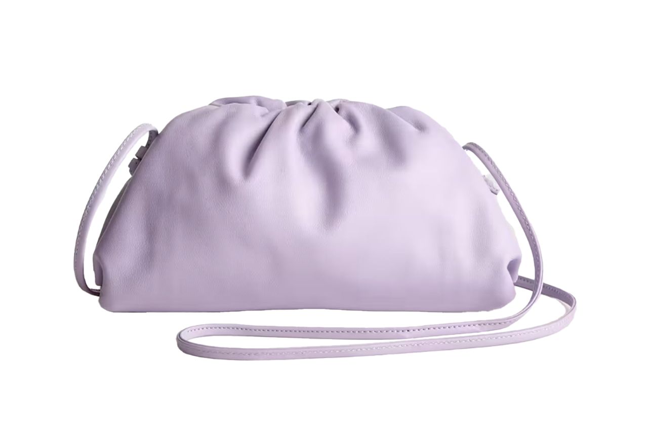A leather crossbody clutch with a drawstring design and long strap Credit: Quince