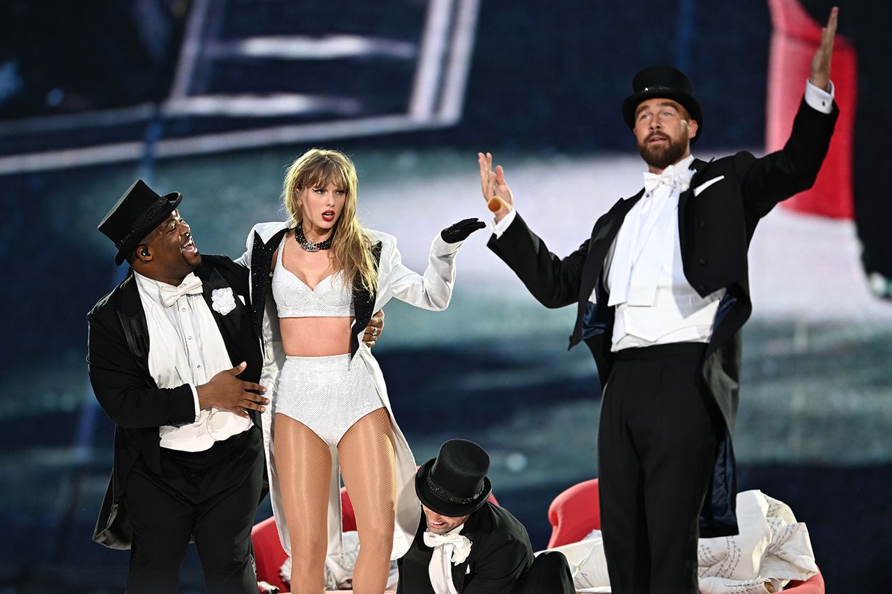 Taylor Swift is joined on stage by Travis Kelce during 