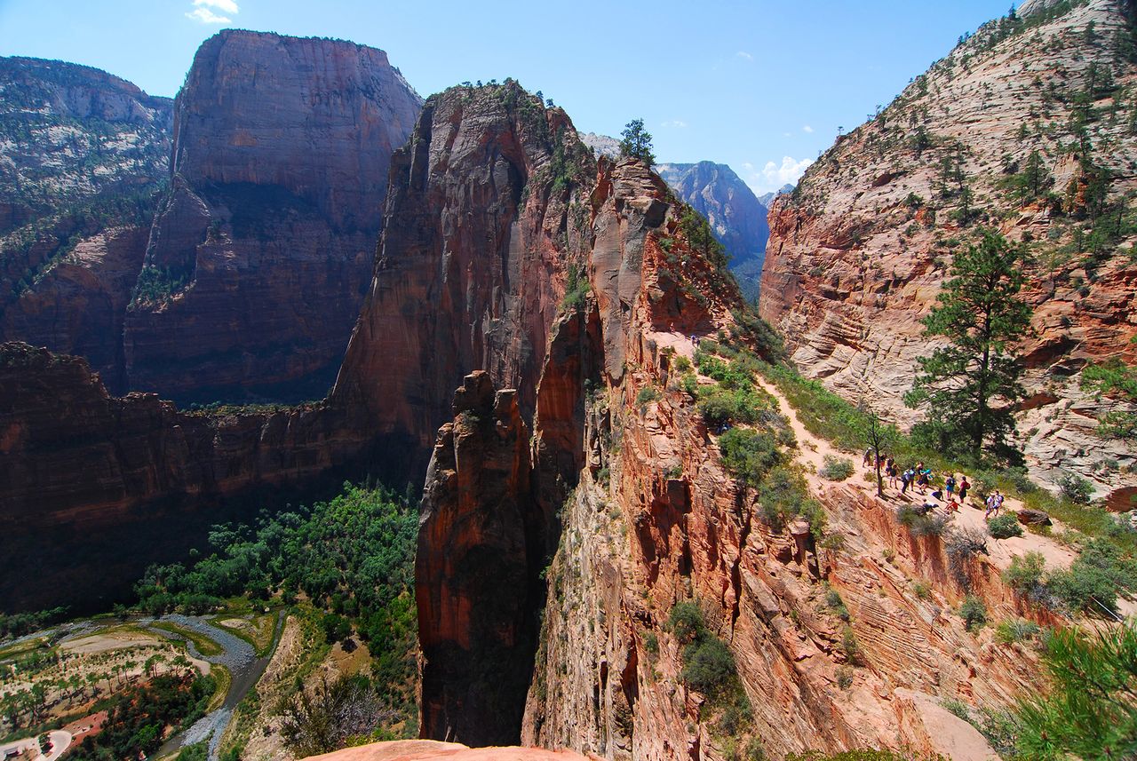 Hikers traversing a narrow trail on a rugged cliff in a mountainous canyon Angels Landing in Zion National ParkCredit: Getty