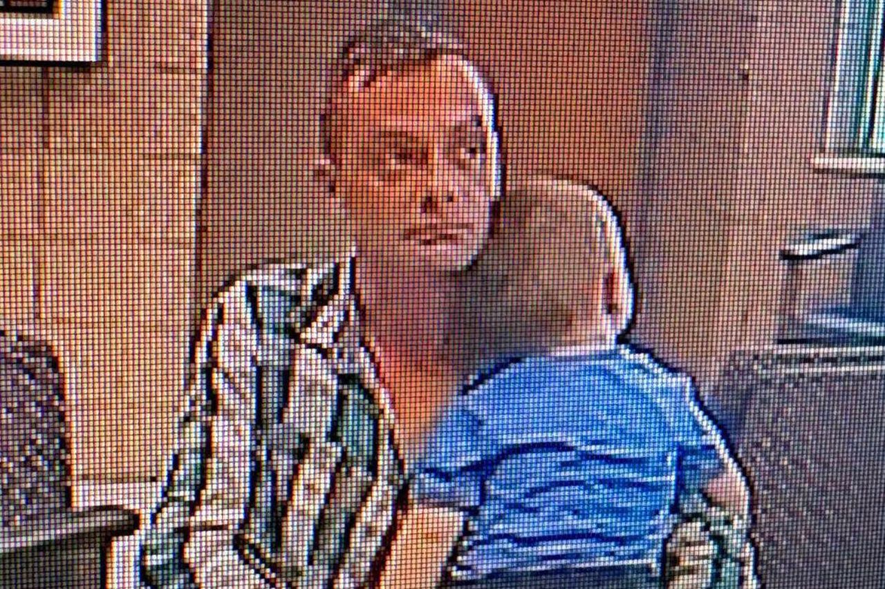 A man seated while holding a small child in his arms indoors Todd Sabatini and TheoCredit: McHenry Police Department/Facebook