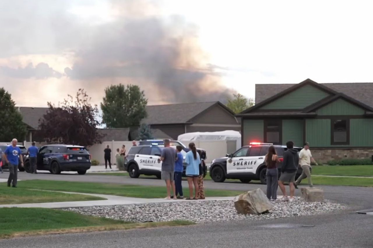 Residents watch on as police respond to the sceneCredit: KTVQ News/Youtube
