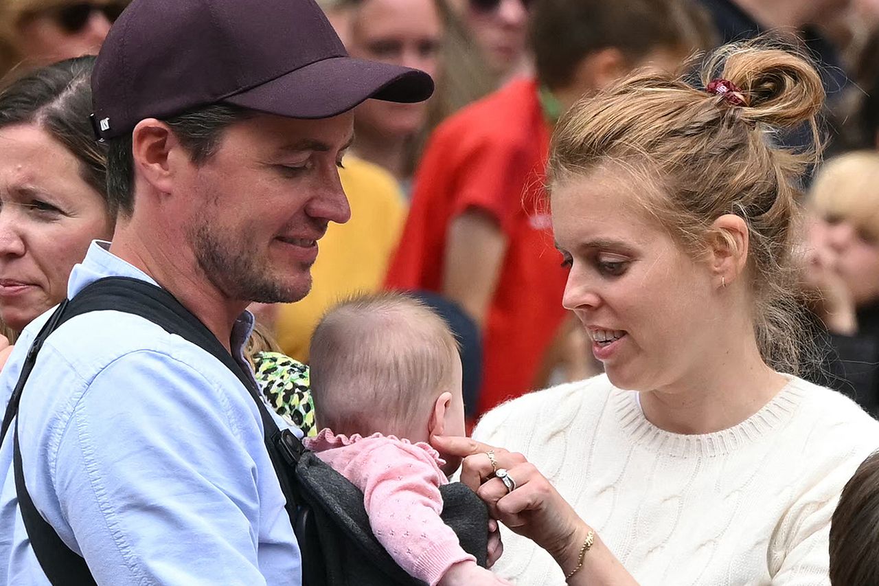 Britain's Princess Beatrice of York (C) her husband Edoardo Mozzi (CL) and children Sienna, Athena and Christopher joins fans lining the Mall waiting to greet the bus carrying the England women's national football team Edoardo Mapelli Mozzi and Princess Beatrice hold daughter Athena as they join fans celebrating the England women’s national football team during their homecoming victory parade near Buckingham Palace in London on July 29, 2025Credit: JUSTIN TALLIS/AFP via Getty