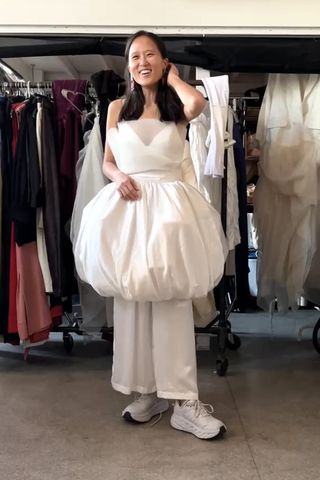 Rebecca Chen trying on wedding dresses in sneakers.Credit: Rebecca Chen