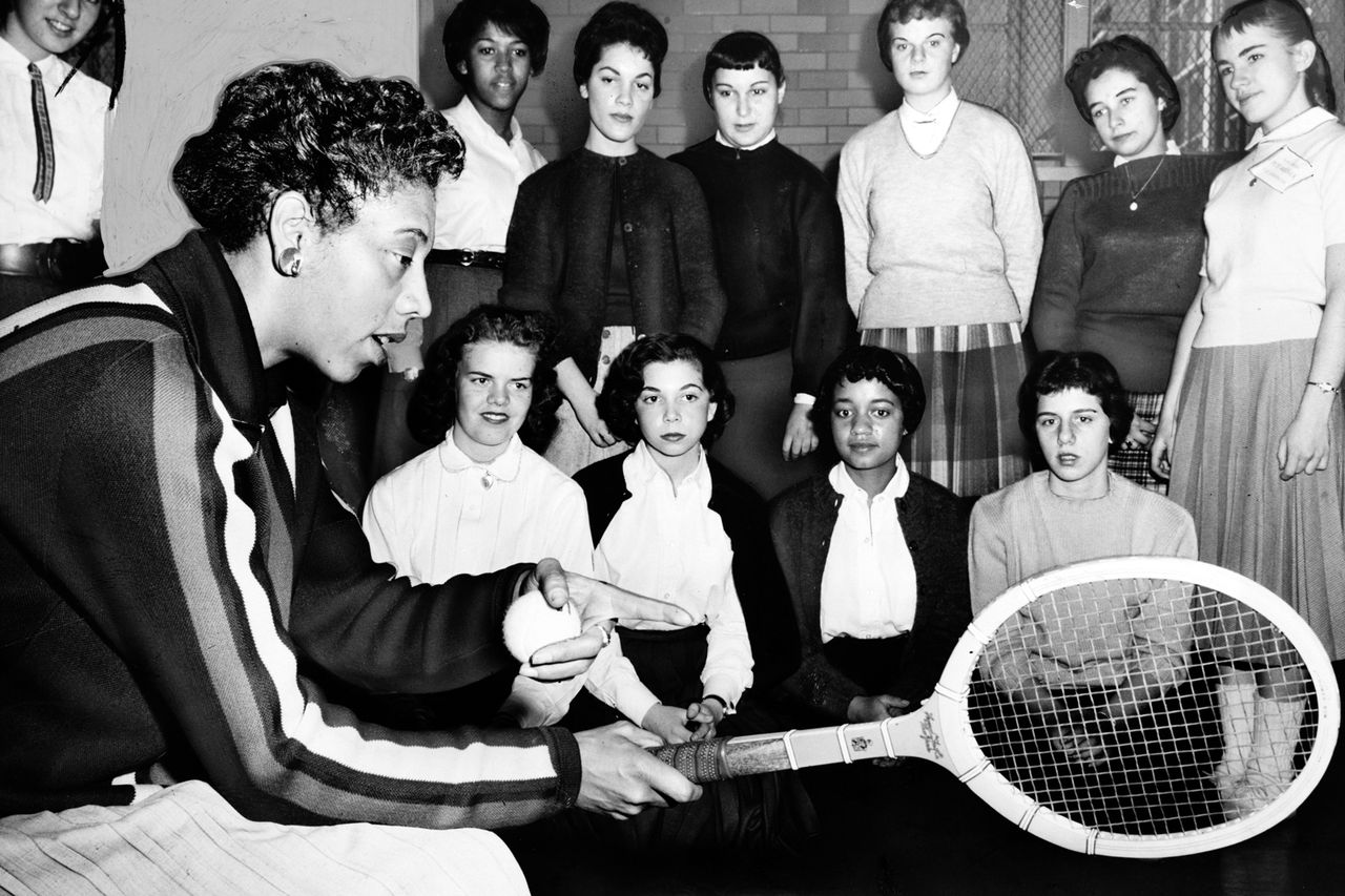 Althea Gibson shows the proper grip for a forehand and gives other pointers to a group of students at Midwood High School in Brooklyn.Credit: Library of Congress/Interim Archives/Getty