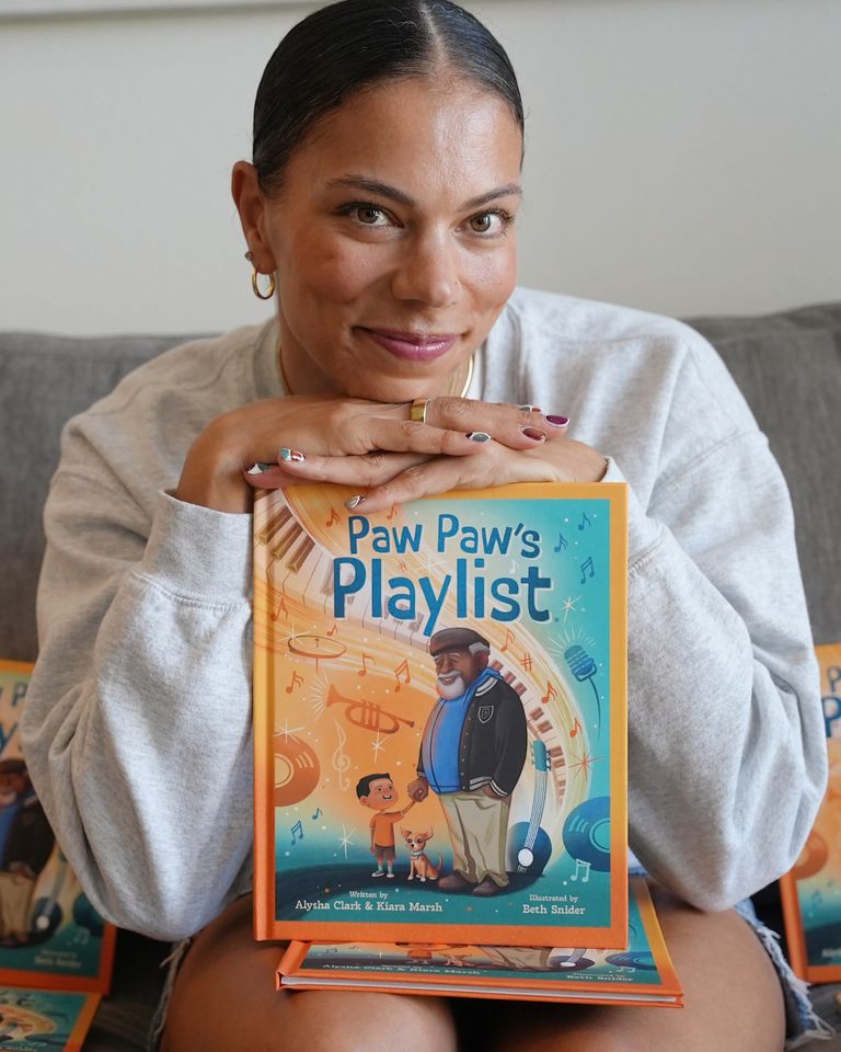 Alysha Clark and her book Paw Paw's Playlist. Alysha ClarkCredit: Be The Good Publishing