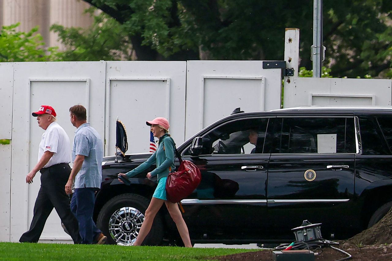 President Donald Trump walks near the White House with aide Natalie Harp on May 16.Credit: Tasos Katopodis/Getty