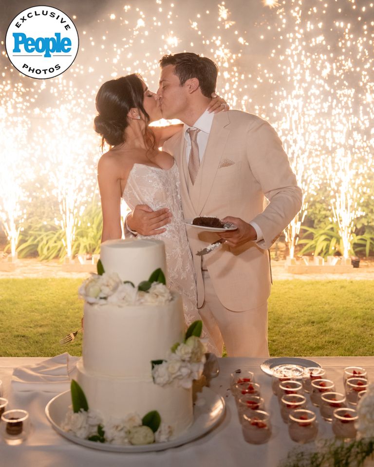 Frank Catania Jr. and bride Nicole at their wedding Frank Catania Jr. and Nicole Perricho kiss in front of their wedding cakeCredit: Michael Zennaro Photography