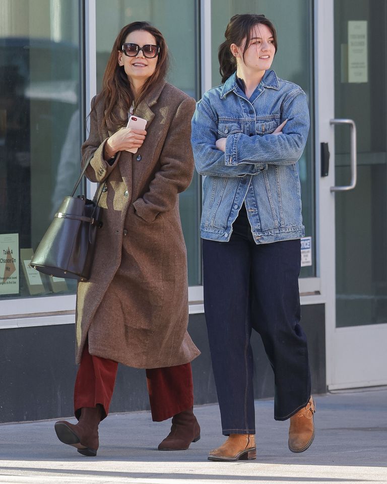Kate Holmes and Suri Cruise are spotted on a stroll in New York City. The lookalike duo were seen enjoying time together on spring break as Suri completes her first year of college. The 18 year old wore a denim jacket with denim jeans and brown boots. Katie wore a long brown coat, maroon trousers and brown boots Kate Holmes and daughter Suri in March 2025.Credit: TheImageDirect.com