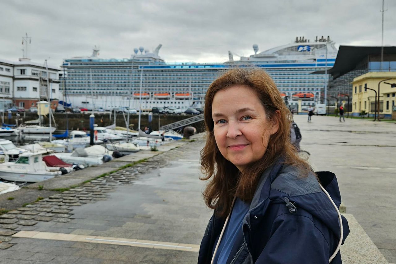 A woman standing near a harbor with a large cruise ship in the background Libby RomeCredit: Courtesy of Libby Rome