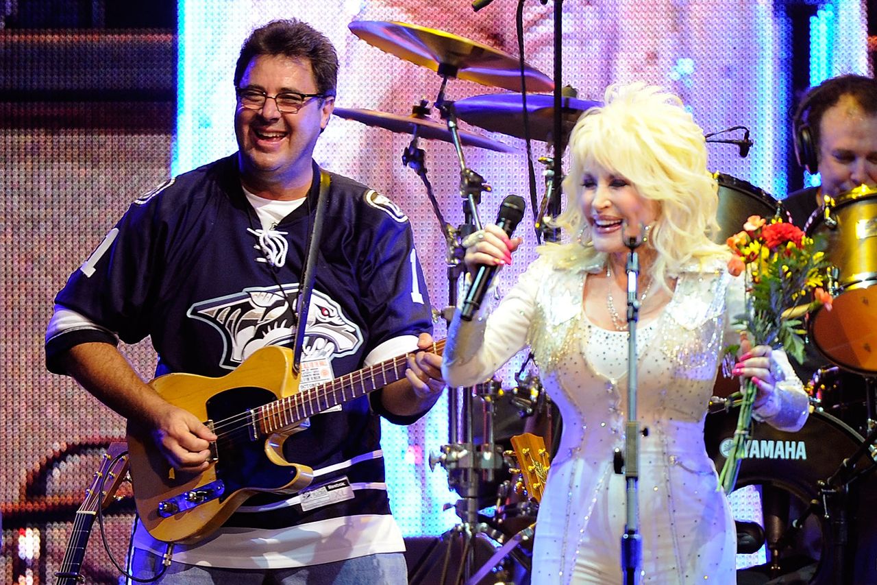 Vince Gill and Dolly Parton onstage in Nashville in 2010Credit: Frederick Breedon/Getty
