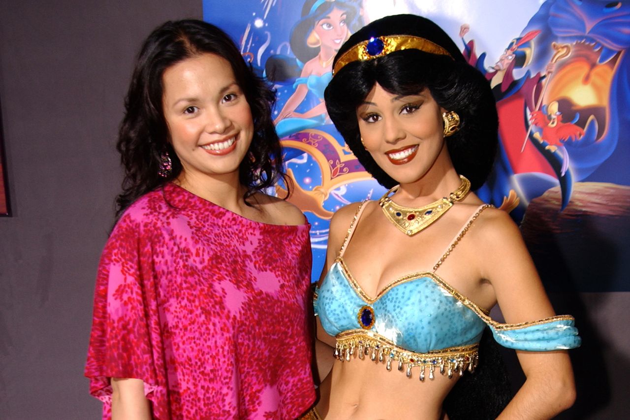 Lea Solanga, singing voice of Princess Jasmine posing with Princess Jasmine characterCredit: Mike Guastella/WireImage