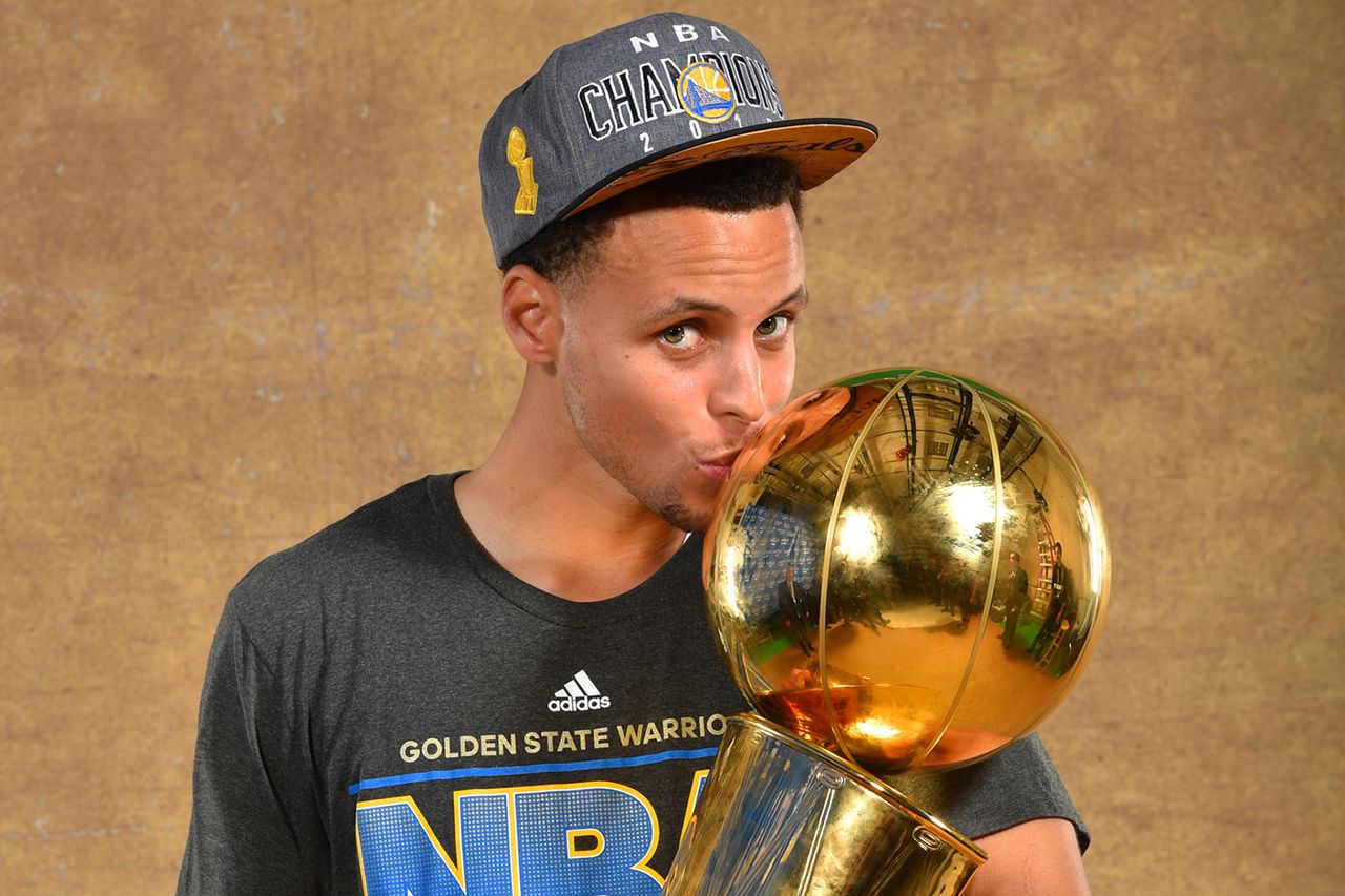 Stephen Curry #30 of the Golden State Warriors poses for a portrait with the Larry O'Brien trophy after defeating the Cleveland Cavaliers in Game Six of the 2015 NBA Finals on June 16, 2015 at Quicken Loans Arena in Cleveland, Ohio. Stephen Curry on June 16, 2015Credit: Jesse D. Garrabrant/NBAE via Getty