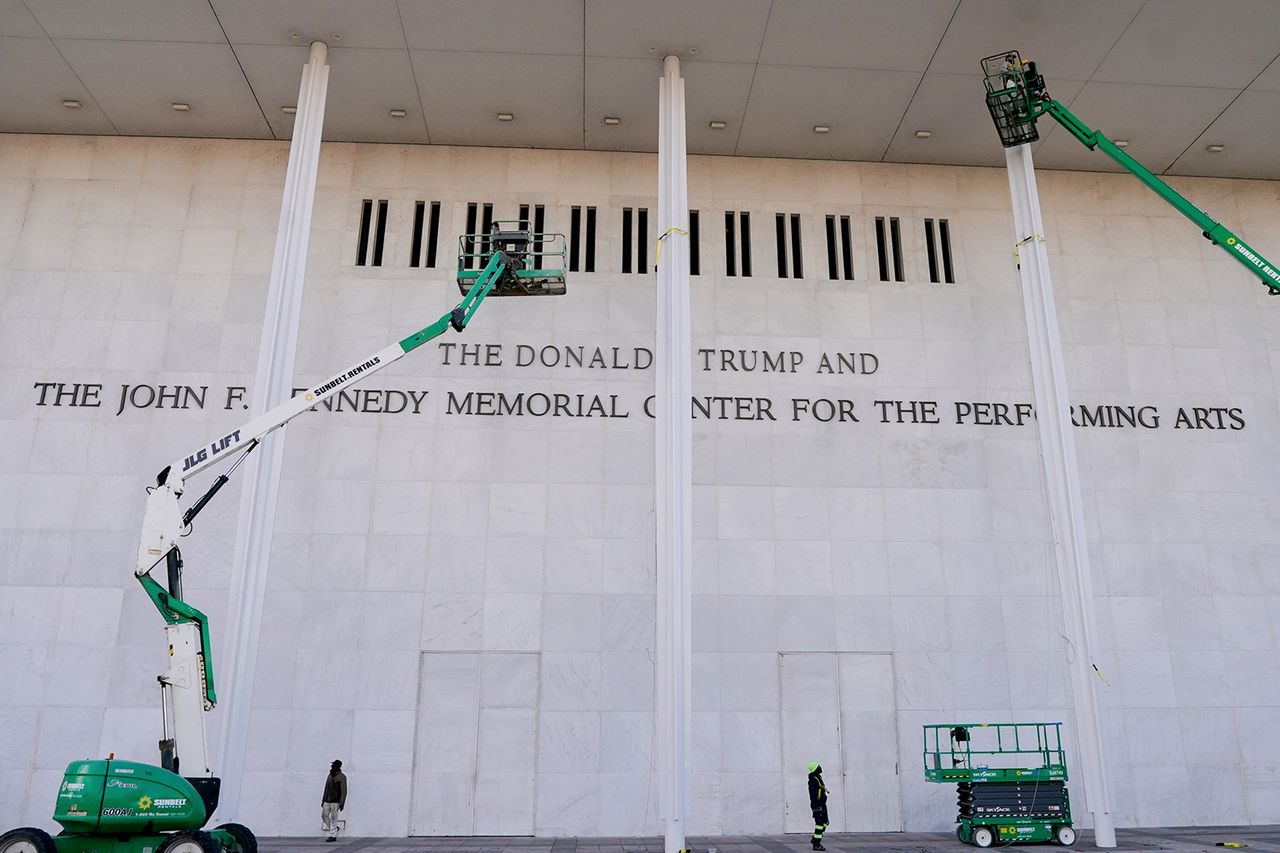 Workers affix signage adding President Donald Trump’s name on the facade of the Kennedy Center on Dec. 19, 2025.Credit: Al Drago/Bloomberg via Getty