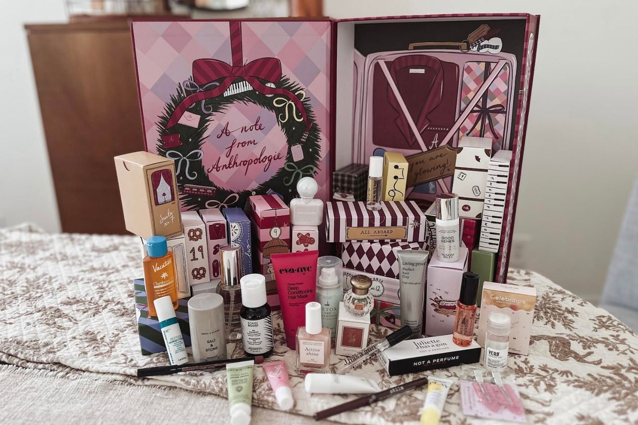 A beauty advent calendar set with multiple miniature cosmetic products displayed on a table Credit: People / Jeaneen Russell