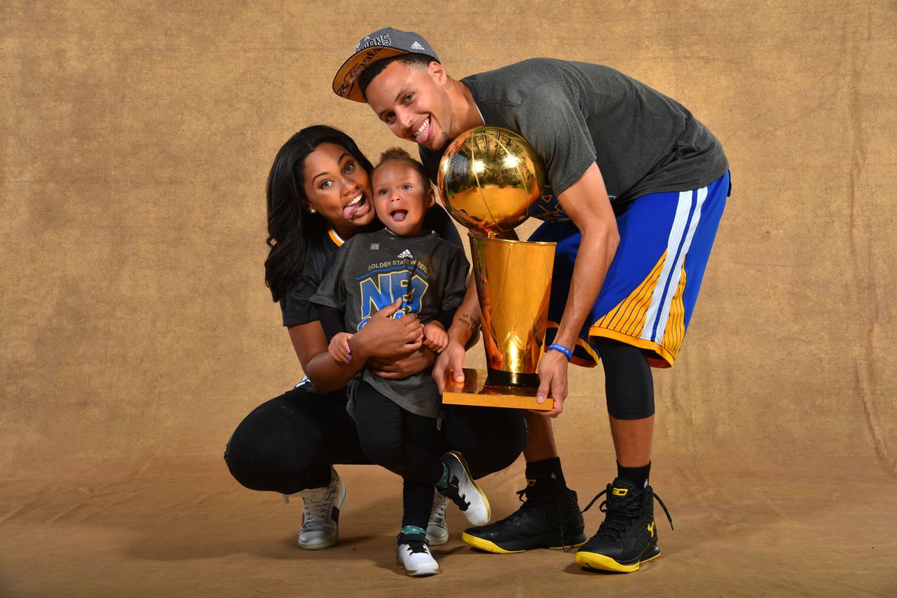 Ayesha Curry, Riley Curry and Stephen Curry #30 of the Golden State Warriors poses for a portrait with the Larry O'Brien trophy after defeating the Cleveland Cavaliers in Game Six of the 2015 NBA Finals on June 16, 2015 Steph and Ayesha Curry with their daughter Riley on June 16, 2015Credit: Jesse D. Garrabrant/NBAE via Getty