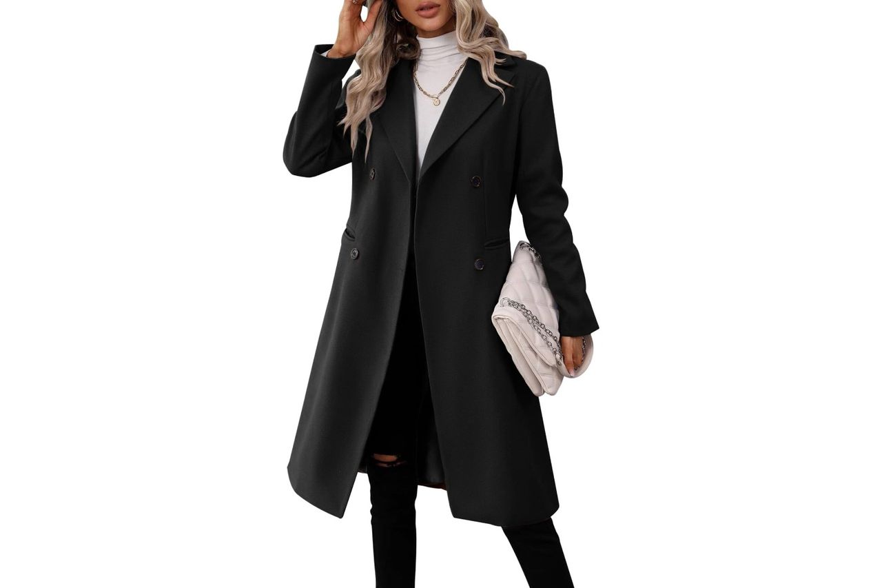 A woman wearing a long doublebreasted coat and holding a bag Credit: Amazon