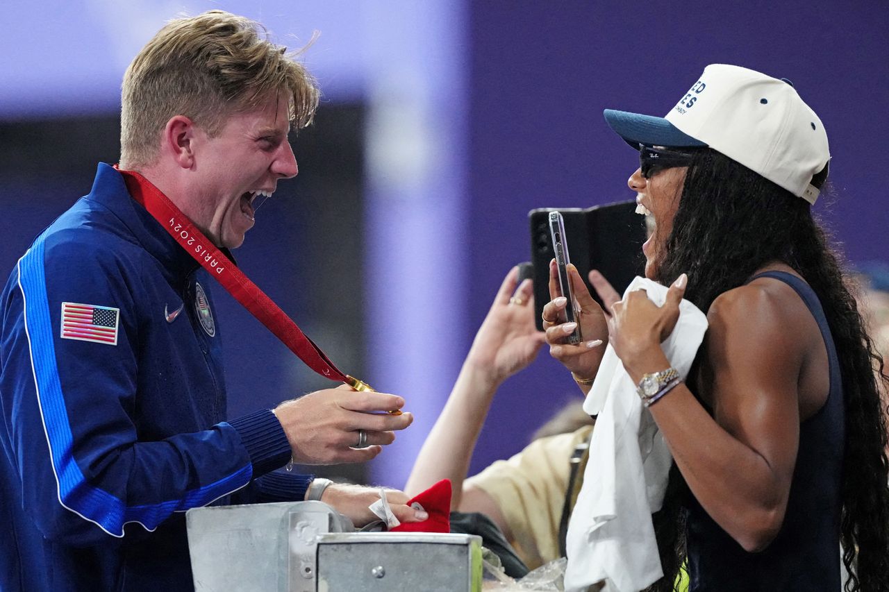 Hunter Woodhall (L) celebrates with his wife Olympic women's long jump champion Tara Davis-Woodhall after the victory ceremony for the Men's 400m T62 final event at the Stade de France in Saint-Denis, outside Paris on September 6, 2024. Hunter Woodhall and Tara Davis-Woodhall at the 2024 ParalympicsCredit: DIMITAR DILKOFF/AFP via Getty