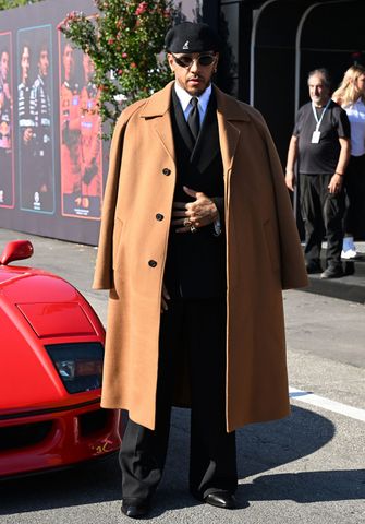 Lewis Hamilton in a suit and coat while posing for photos ahead of the Italian Grand PrixCredit: Mark Sutton/Formula 1/Getty