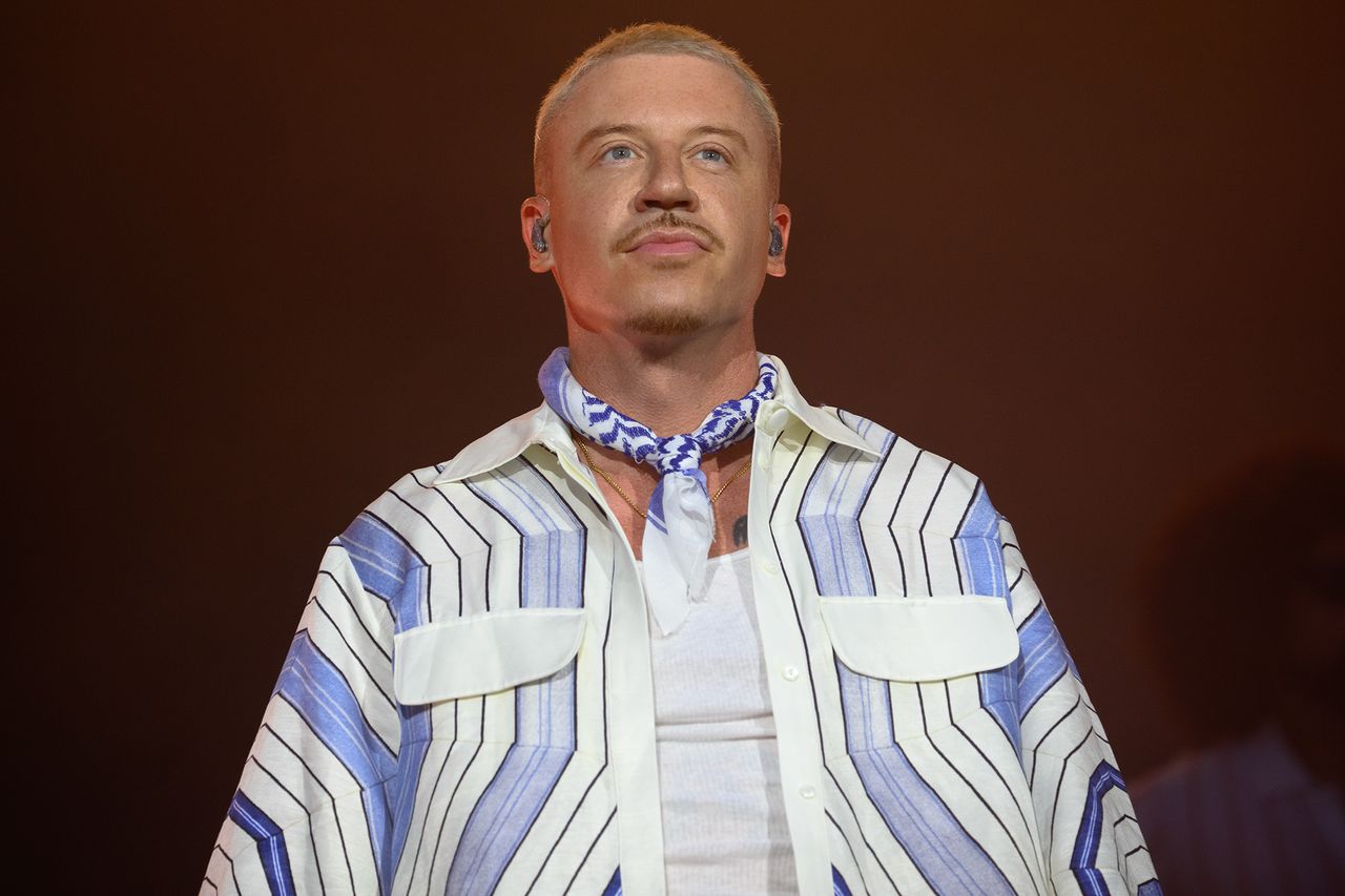 Macklemore standing wearing a striped shirt and scarf Macklemore in July 2025 in ParisCredit: Kristy Sparow/Getty
