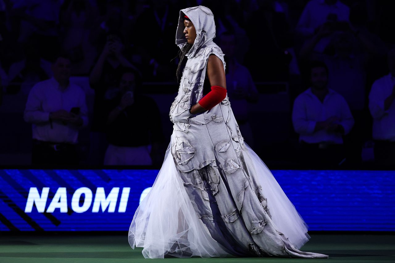 A person in an elaborate outfit walks on a stage with the text Naomi displayed in the background Naomi Osaka at the U.S. Open on Aug. 31, styled by Law Roach.Credit: Patrick Smith/Getty