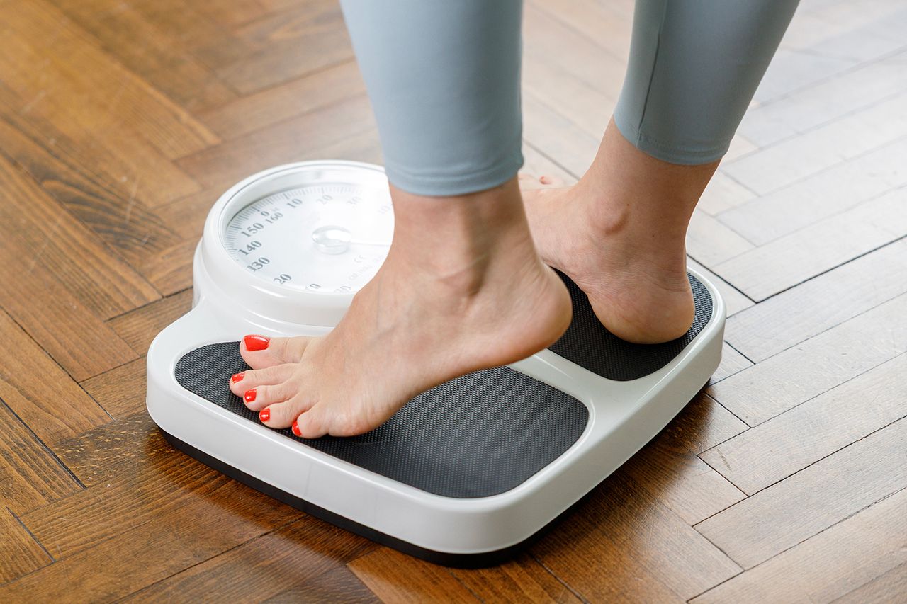 Stock image of a woman weighing herself at homeCredit: Getty