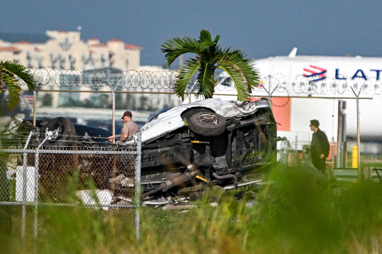 Officials investigate the scene where cars were damaged after a Prime Air cargo plane overran the runway and struck vehicles at Miami International Airport in Miami, Florida, on September 6, 2026Credit: CHANDAN KHANNA / AFP via Getty