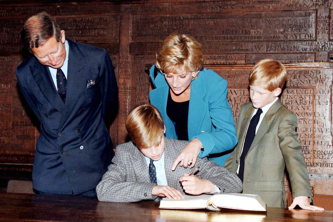 Prince William signs in on his first day at Eton College, Sept. 6, 1995, as Prince Charles, Princess Diana and Prince Harry look on.Credit: Anwar Hussein/WireImage